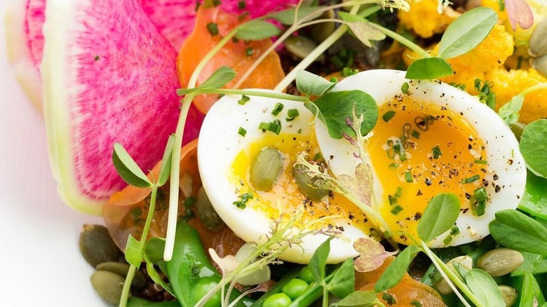 runny egg on salad