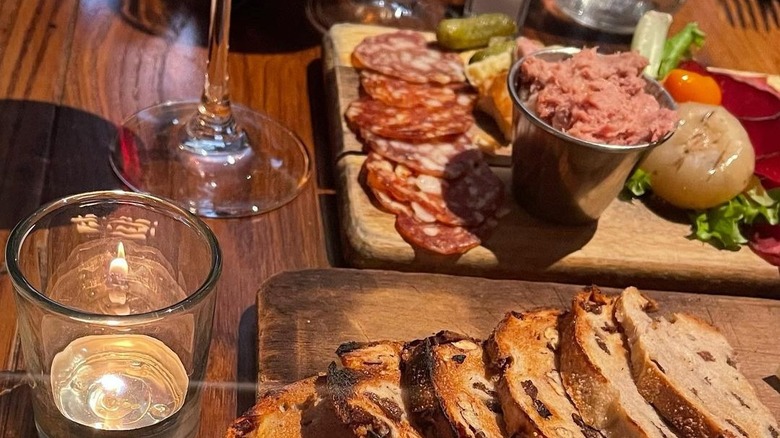 Charcuterie and candle on table