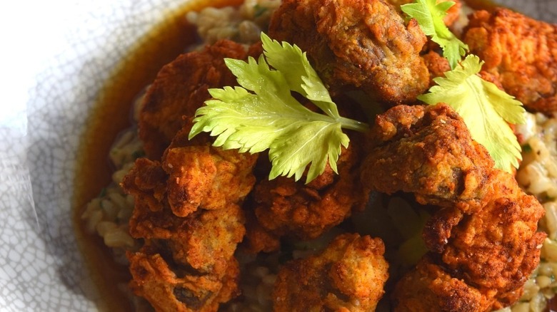 Fried chicken gizzards over rice