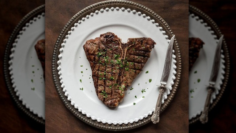 Plated T-bone steak with knife
