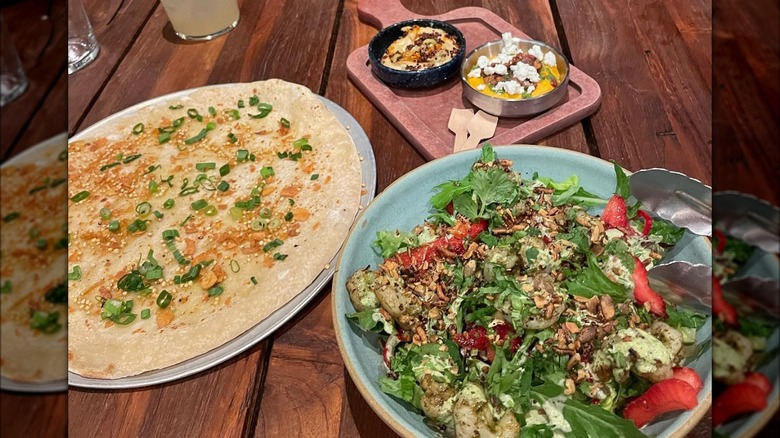 naan and dip and shrimp salad on wooden table