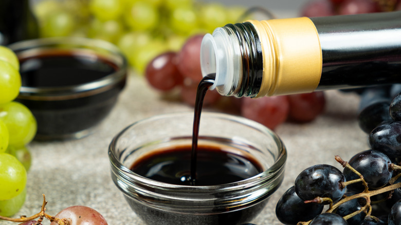 Pouring balsamic from glass container