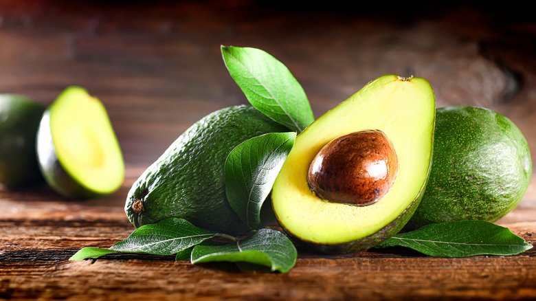 Sliced avocado on wooden board