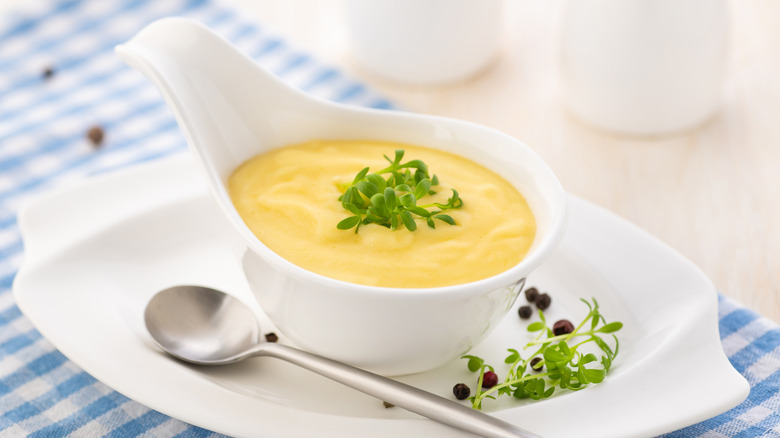 Hollandaise sauce in white bowl