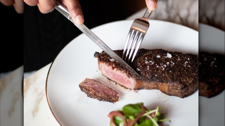 Steak cut with utensils