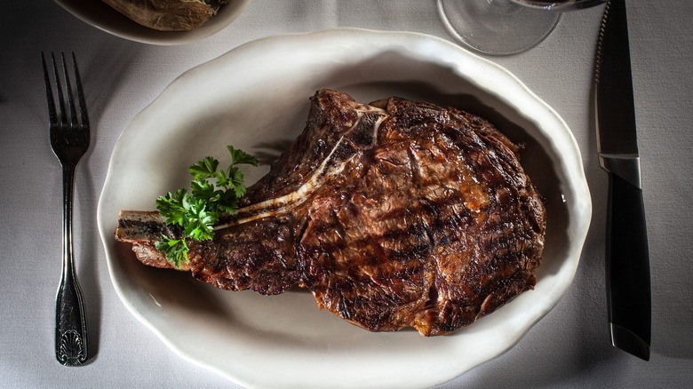 t-bone steak on white plate