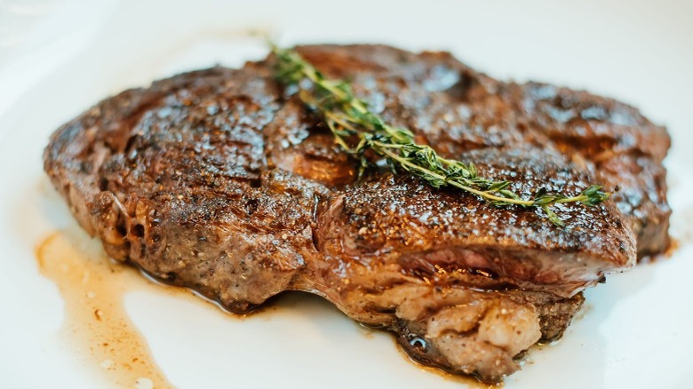 Steak and rosemary on plate 