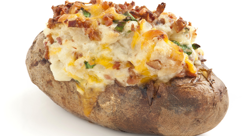 Loaded potato against white backdrop