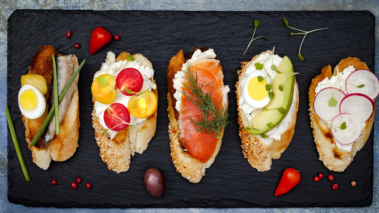 Open-faced sandwiches on slate board