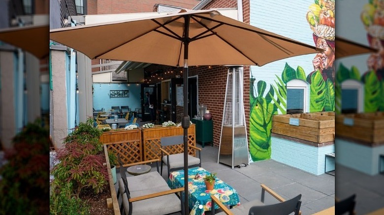 Brown umbrella over colorful table