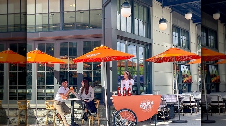 Orange cart under umbrellas