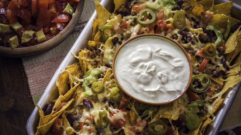 sour cream atop baked nachos 