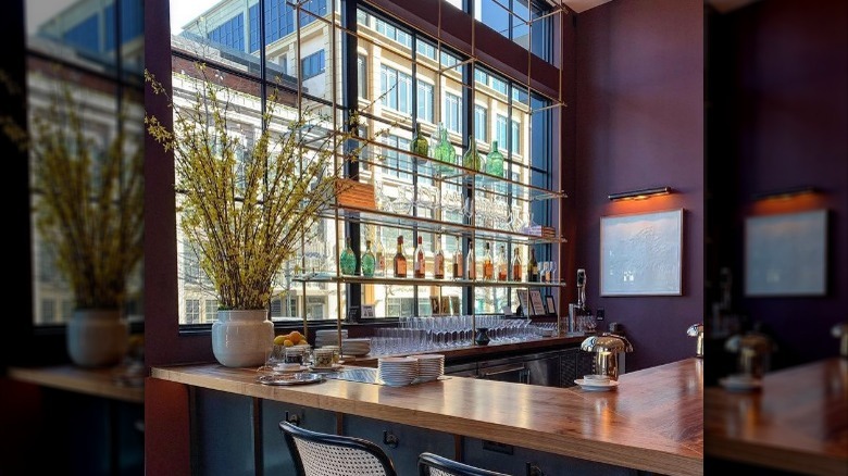 Wooden bar and maroon walls at Lucian Books & Wine