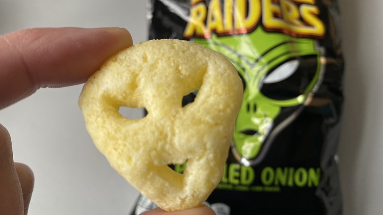 Space raider pickled onion chip in hand