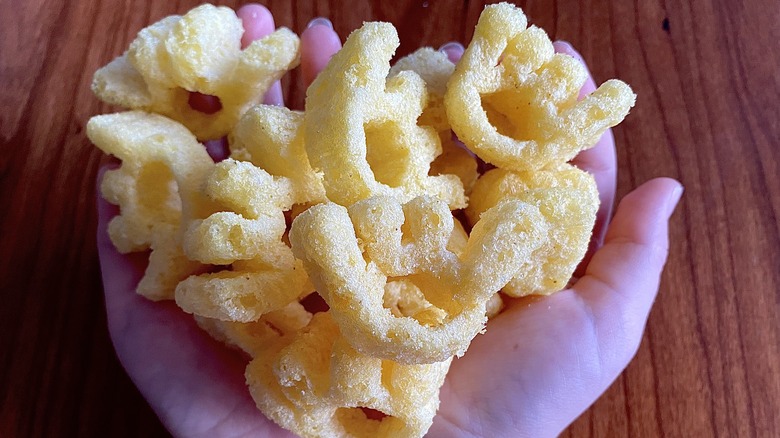 Walkers monster munch crisps in child's hands 