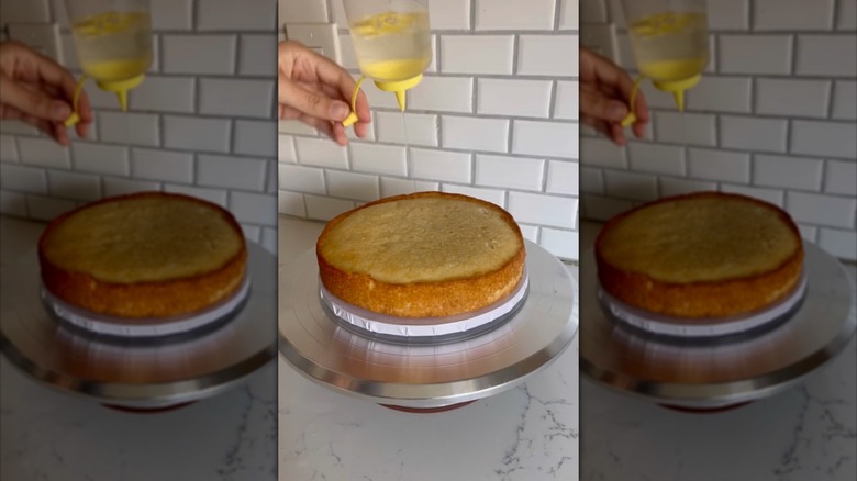 drizzling simple syrup on cakes