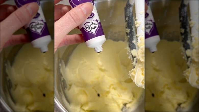 adding purple food coloring to frosting