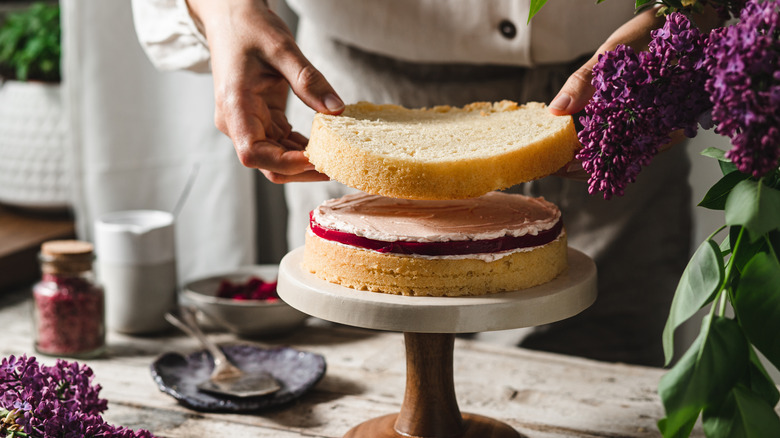 Person stacking layer cake pieces