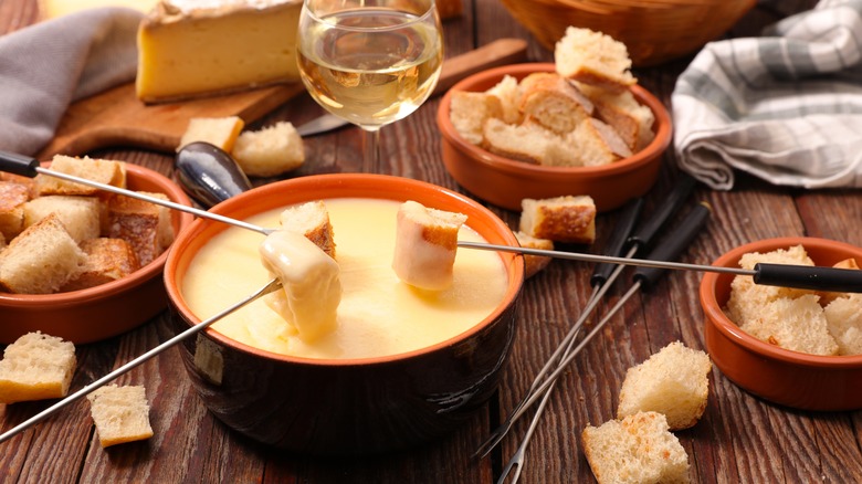 Dipping bread in French fondue