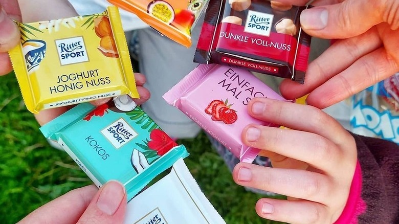 Hands holding Ritter Sport chocolates