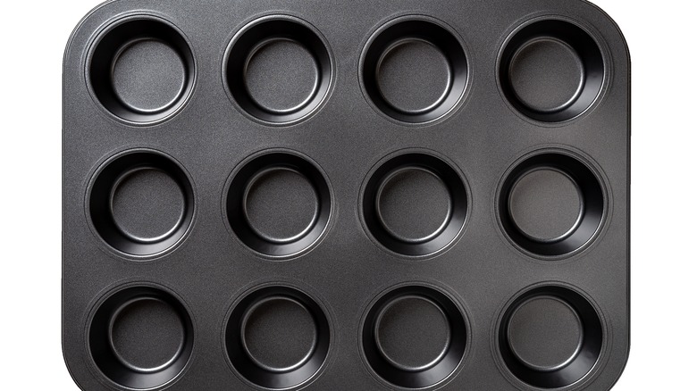 Muffin tin on white background