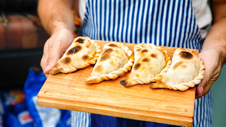 Empanadas on brown wood board