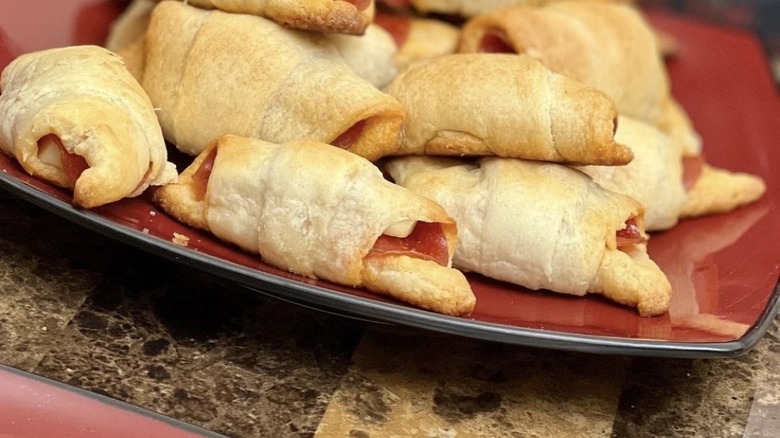 Pizza rolls on red plate