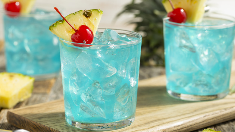 Blue cocktails with fruit garnish