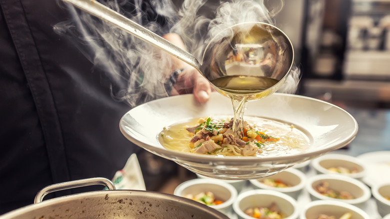 ladle pouring broth