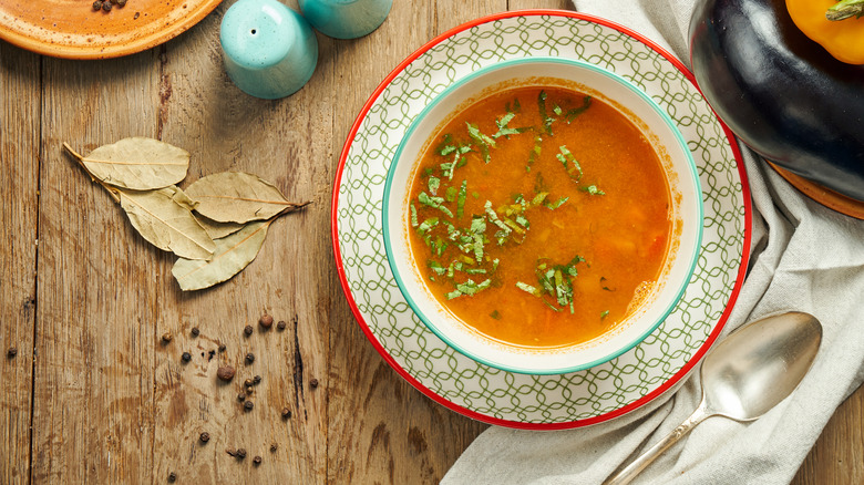 red soup with green herbs