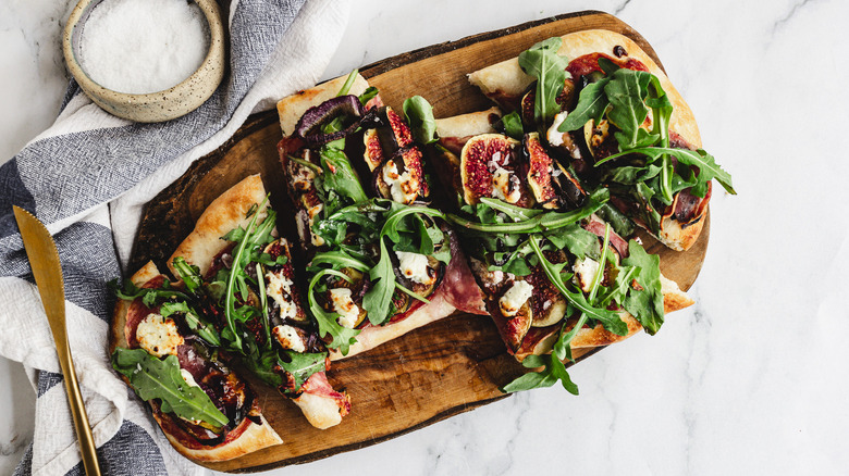 sliced flatbread on wooden board