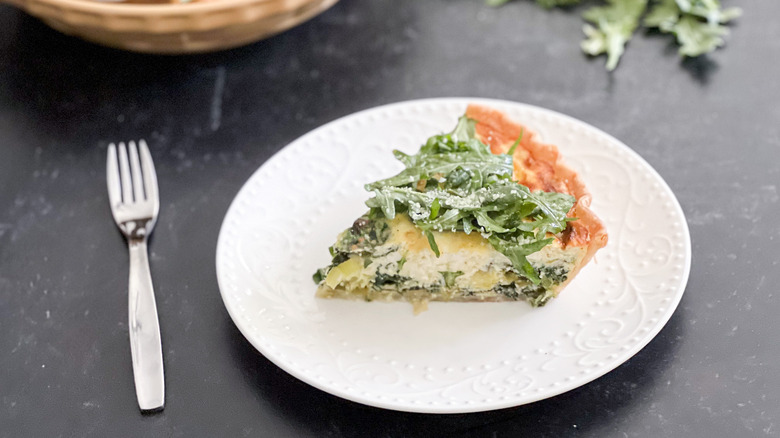 arugula quiche slice on plate