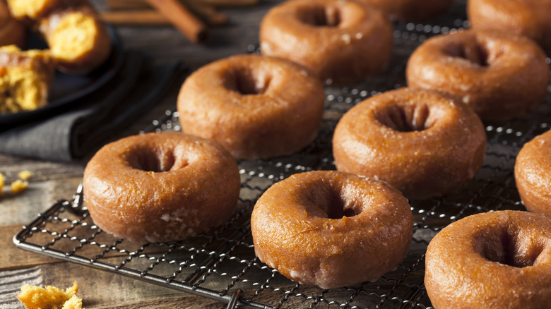 Donuts sitting on wire rack