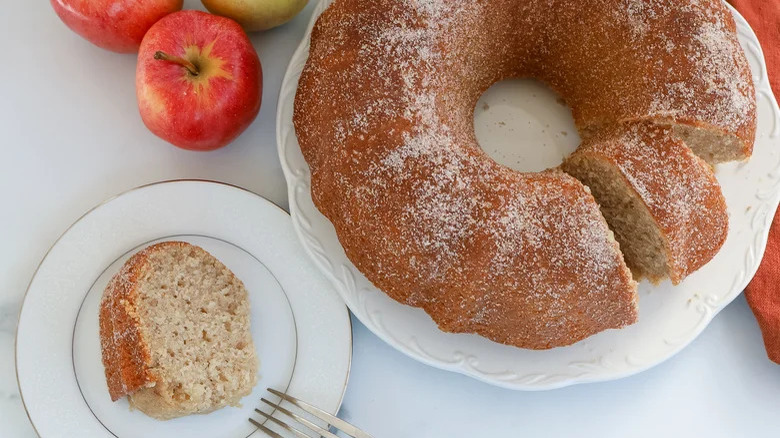 Slice with whole apple cake 