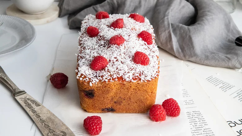 Raspberry coconut cake with knife 