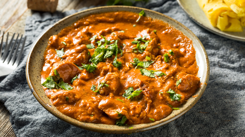 Bowl of chicken tikka masala on a tablecloth