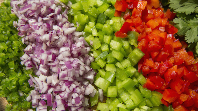 Colorful diced veggies arranged in rows by color