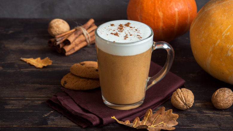 Pumpkin spice latte with cookies, spices and pumpkins