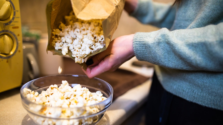 Pouring popcorn into a bowl