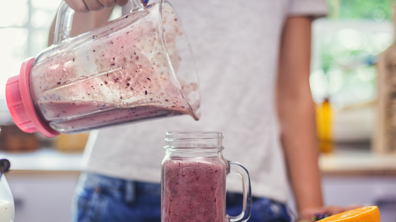 Pouring smoothie into glass