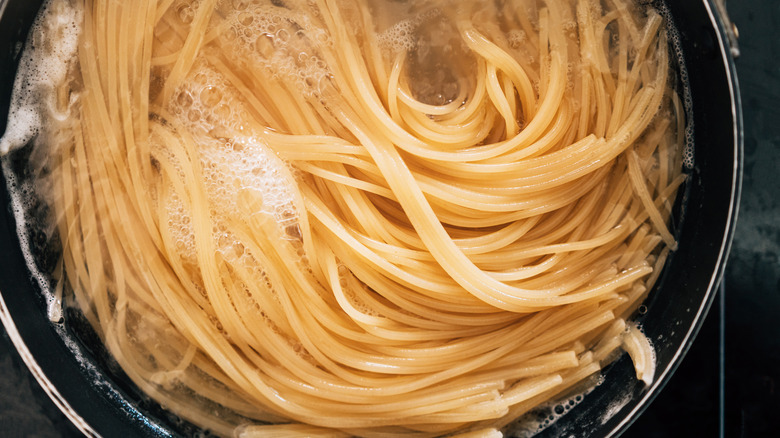 spaghetti cooking in pot