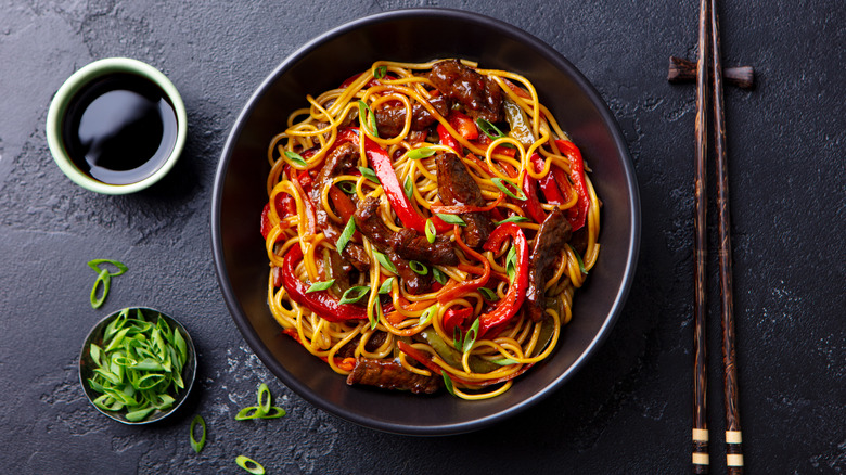 beef pepper and noodle stir fry with scallions and dark soy sauce