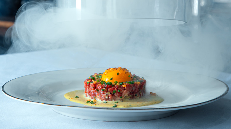 Steak tartare under glass Bistro LeRoux