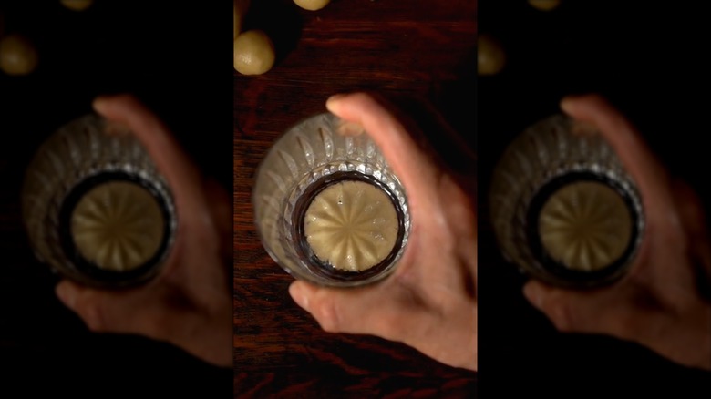 pressing cookie dough with glass