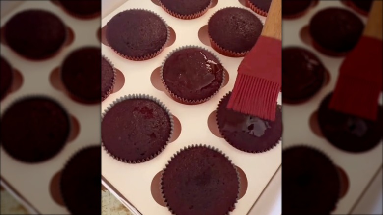 brushing cupcakes with simple syrup