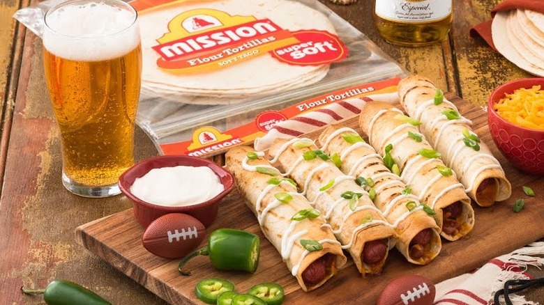 Hot dog taquitos on cutting board