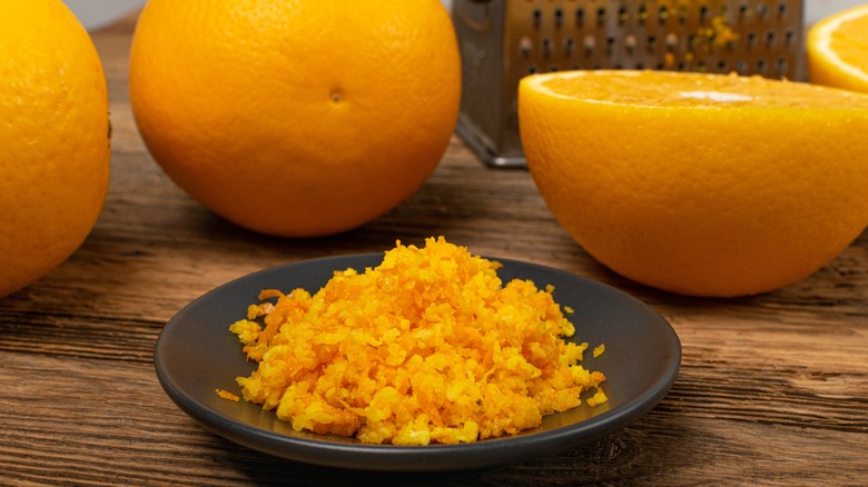 Oranges with zest on plate