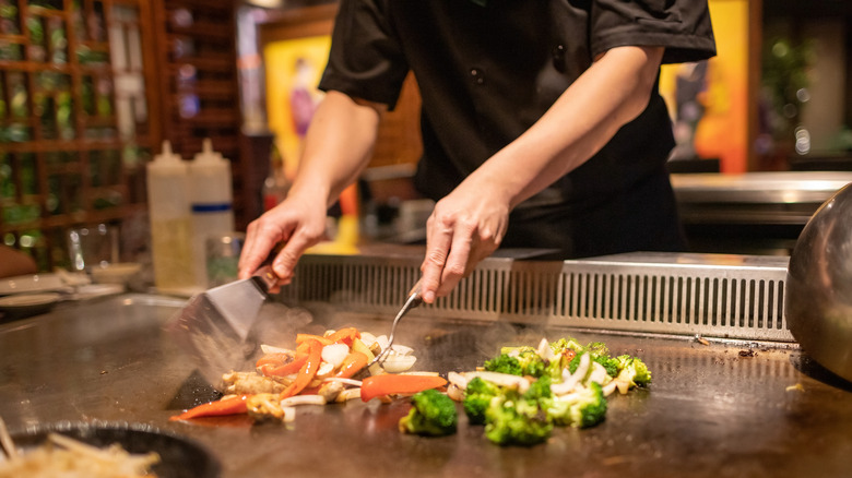 chef cooking on teppanyaki grill