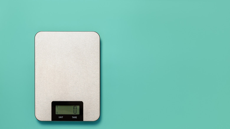 Kitchen scale on turquoise background