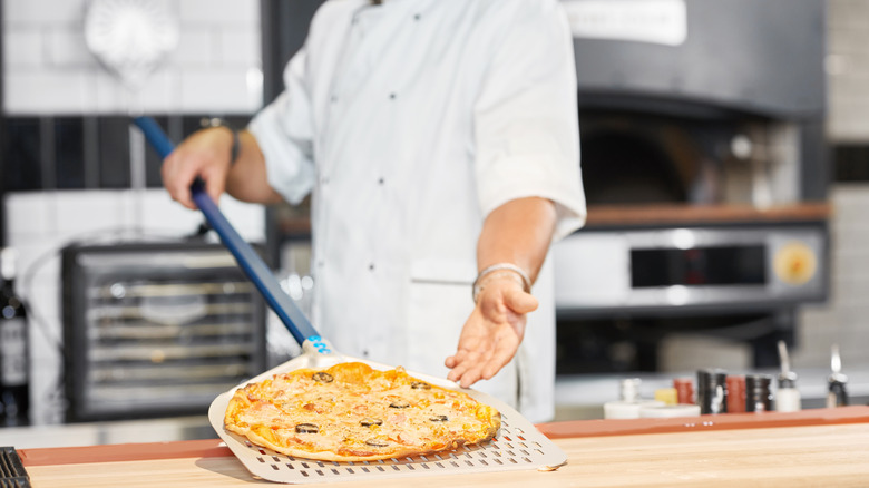 Person handling long-handle peel